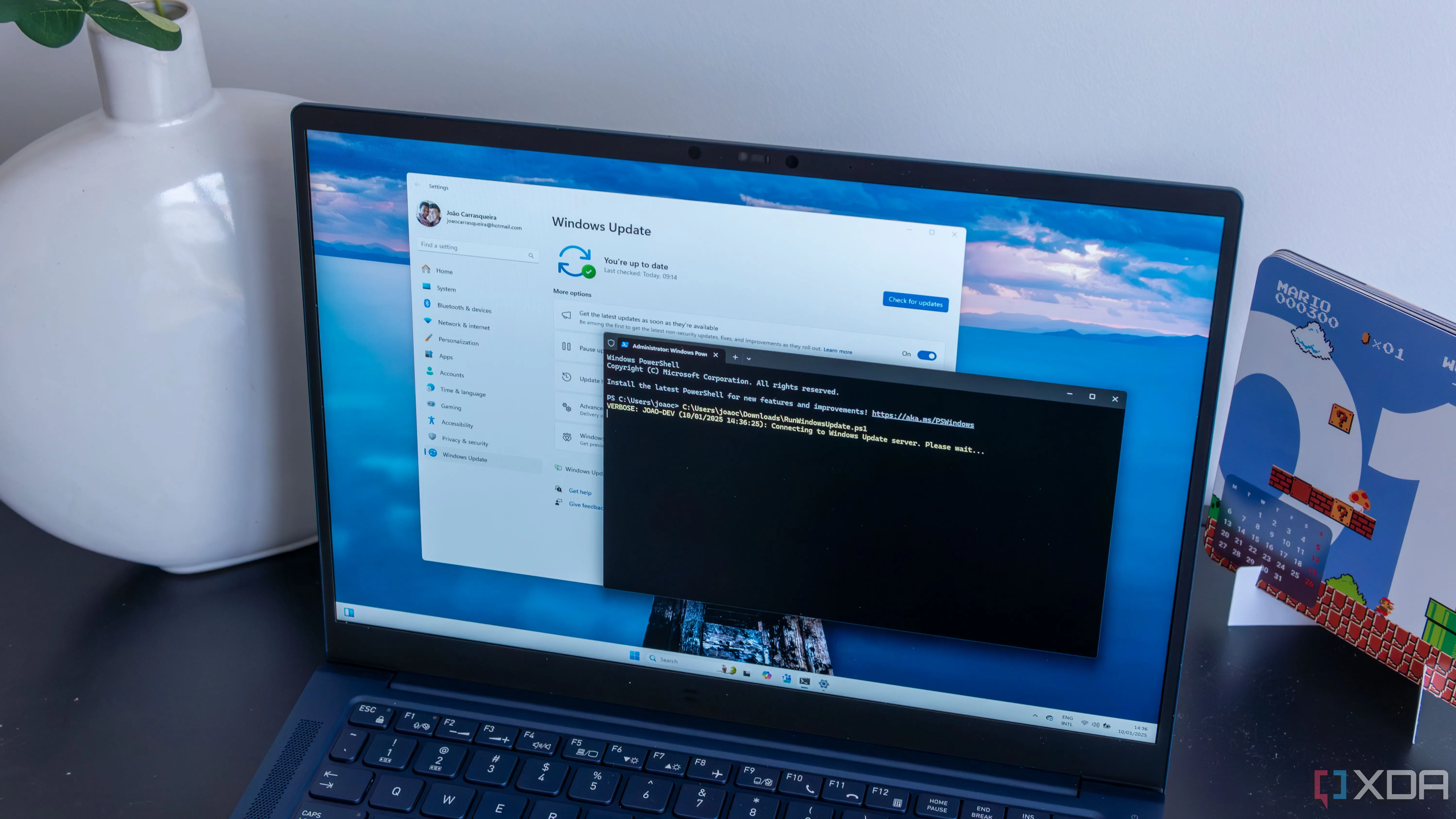 Laptop Windows 11 chạy script PowerShell để cài đặt và khởi động lại cập nhật