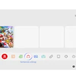Mô tả ảnh: Ảnh chụp màn hình giao diện chính (home screen) của Nintendo Switch 2, với nền trắng và các ô game hình vuông, thể hiện sự tương đồng với UI của Switch đời đầu.