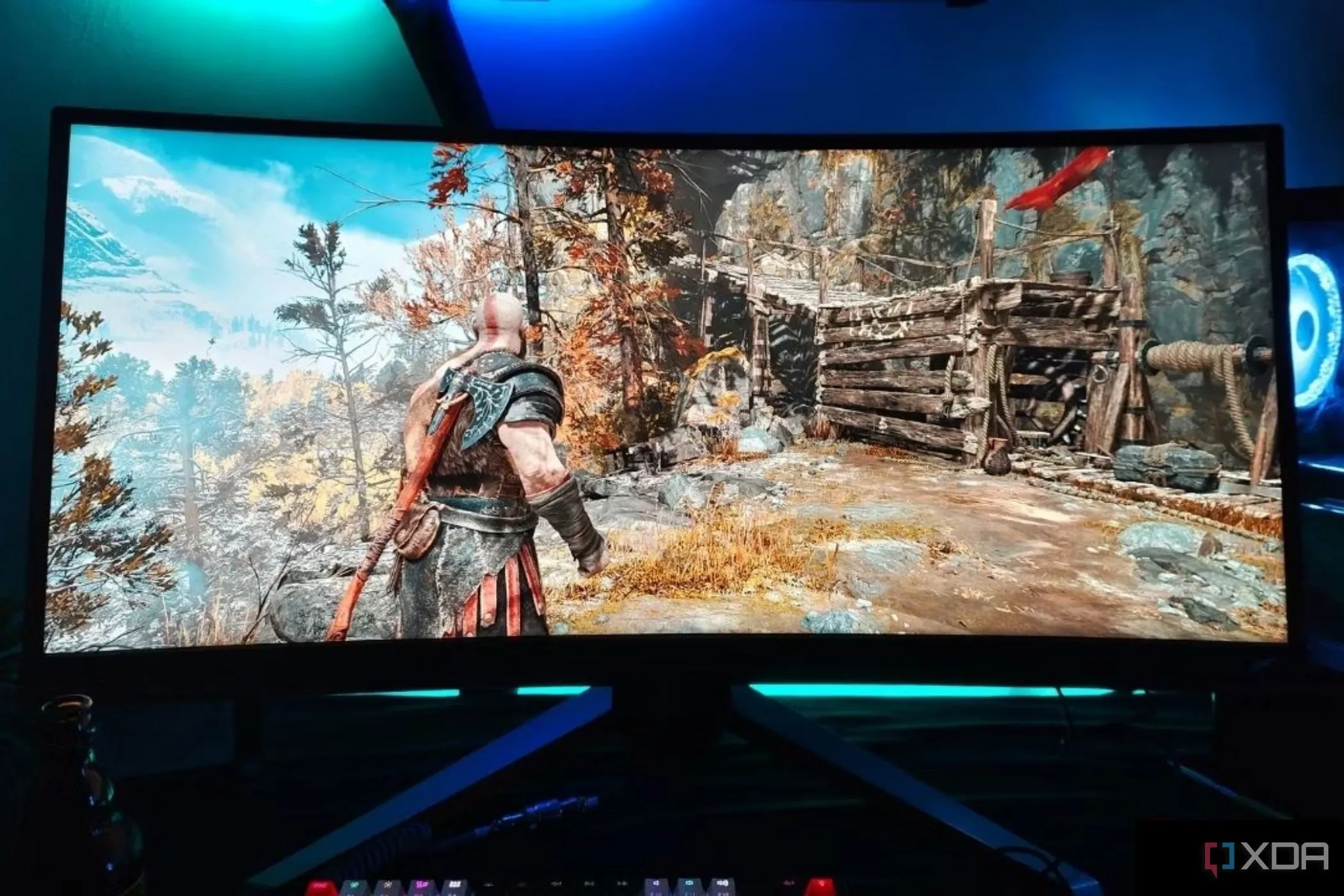 Một màn hình BenQ Mobiuz EX3415R siêu rộng hiển thị cảnh chơi game God Of War, cho thấy góc nhìn rộng và sống động